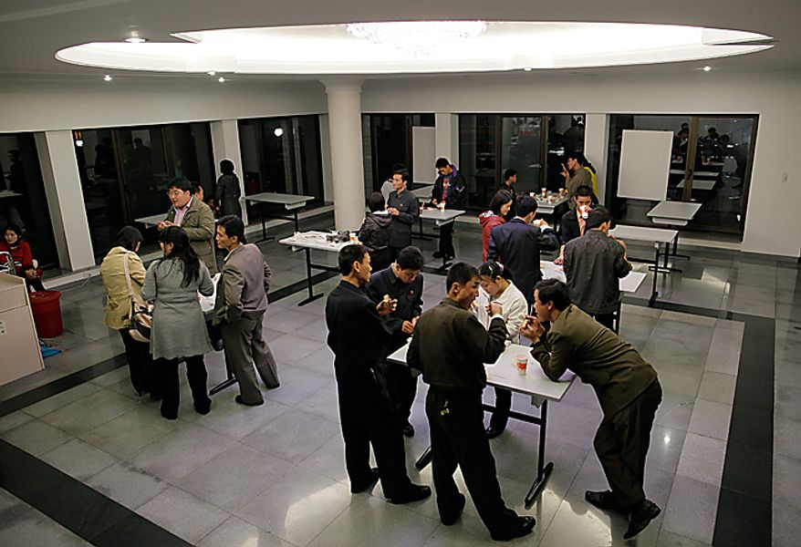 In this Monday, Oct. 11, 2010 photo, North Koreans eat at a fast food restaurant in a park in Pyongyang, North Korea. North Koreans took a long weekend to celebrate a major political anniversary and the unveiling of leader Kim Jong Il's heir-apparent in scenes of revelry that contradicted the shortages normally associated with this reclusive country. (AP Photo/Vincent Yu)