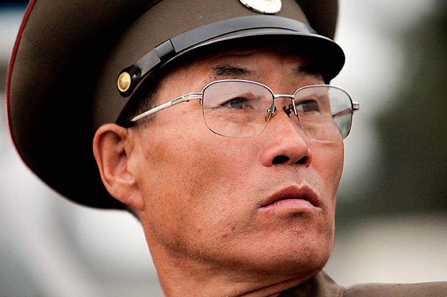 A member of the North Korean military attends a parade commemorating the 65th anniversary of the Korea Worker's Party in Pyongyang, North Korea, on Sunday, Oct. 10, 2010. North Korean heir apparent Kim Jong Un stood at his father's right side today as they reviewed troops, tanks and missiles in a Pyongyang military parade. Photographer: Dieter Depypere/Bloomberg