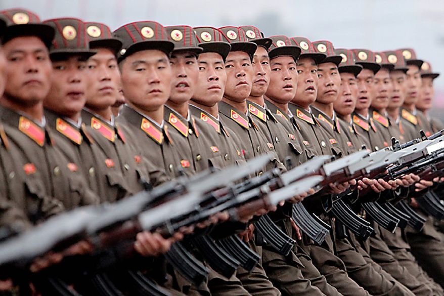 Members of the North Korean military march during a parade commemorating the 65th anniversary of the Korea Worker's Party in Pyongyang, North Korea, on Sunday, Oct. 10, 2010. North Korean heir apparent Kim Jong Un stood at his father's right side today as they reviewed troops, tanks and missiles in a Pyongyang military parade. Photographer: Dieter Depypere/Bloomberg