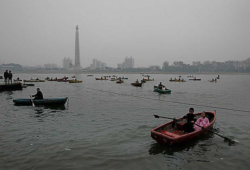 North Korean rowing boats at the Taedong River in Pyongyang, North Korea on Monday, Oct. 11, 2010. The party in Pyongyang stretched into Monday as North Koreans took the day off to celebrate a major political anniversary and to revel in the unveiling of leader Kim Jong Il's heir-apparent, son Kim Jong Un. (AP Photo/Vincent Yu)