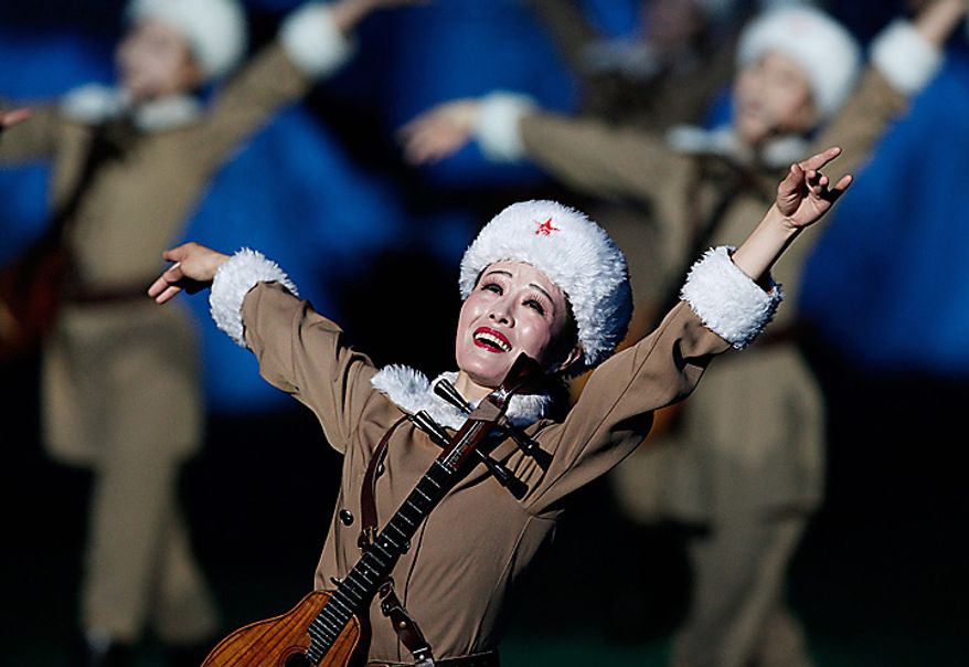 A North Korean dancer performes during a Arirang mass games to mark the 65th anniversary of the communist nation's ruling Workers' Party in Pyongyang, North Korea on Saturday, Oct. 9, 2010. Leader Kim Jong Il brought dancers at the Arirang mass games to tears Saturday by making a rare appearance at the festival on the second day of celebrations in the North Korean capital. (AP Photo/Vincent Yu)