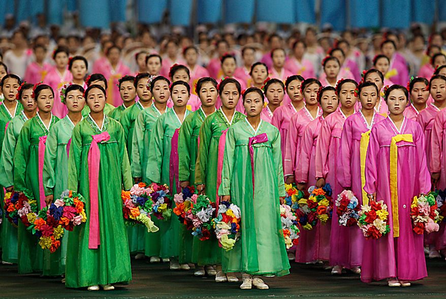 North Korean dancers perform during a Arirang mass games to mark the 65th anniversary of the communist nation's ruling Workers' Party in Pyongyang, North Korea on Saturday, Oct. 9, 2010. Leader Kim Jong Il brought dancers at the Arirang mass games to tears Saturday by making a rare appearance at the festival on the second day of celebrations in the North Korean capital. (AP Photo/Vincent Yu)