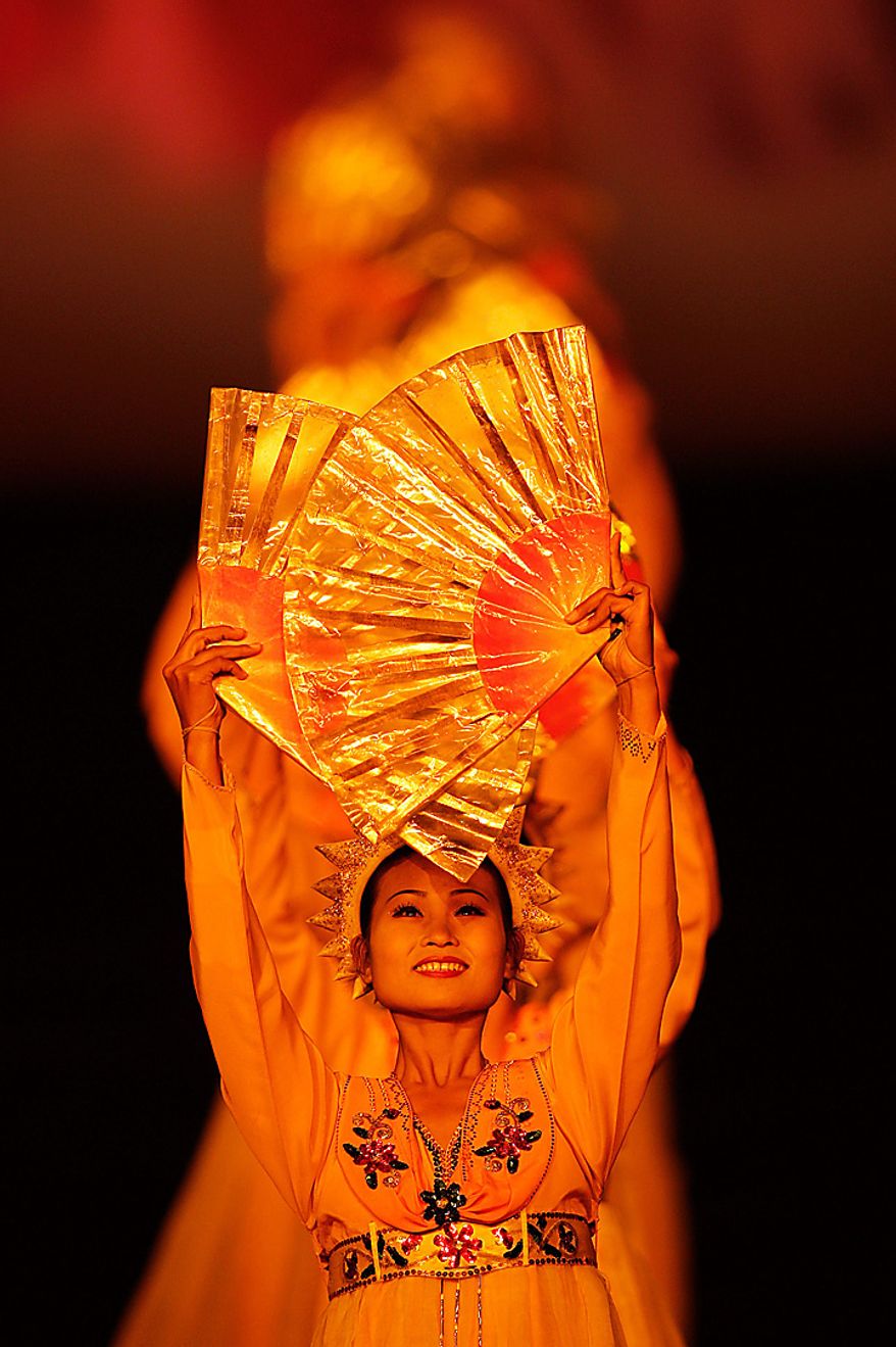 A North Korean dancer performes during a Arirang mass games to mark the 65th anniversary of the communist nation's ruling Workers' Party in Pyongyang, North Korea on Saturday, Oct. 9, 2010. Leader Kim Jong Il brought dancers at the Arirang mass games to tears Saturday by making a rare appearance at the festival on the second day of celebrations in the North Korean capital. (AP Photo/Vincent Yu)