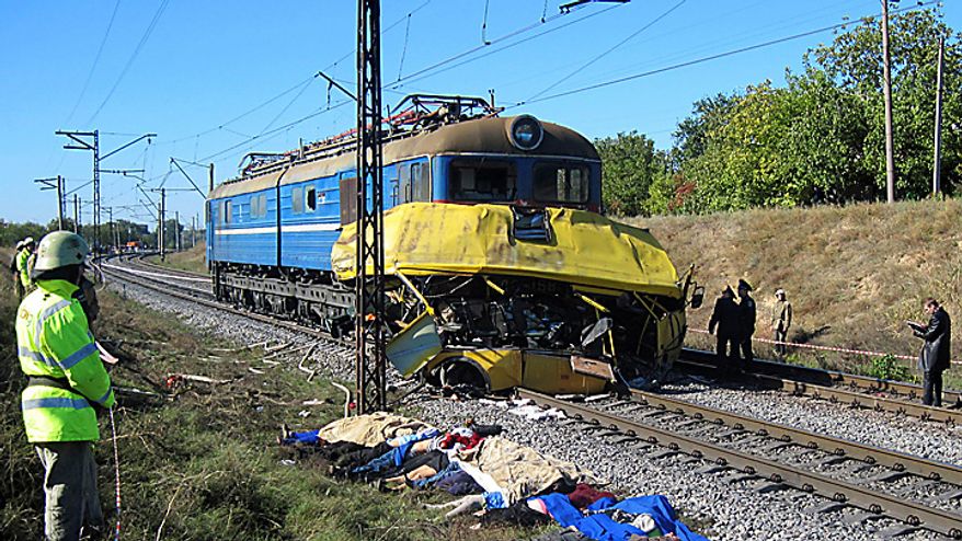 Victims bodies lie at the side of the track at the scene of an accident outside the town of Marhanets, Ukraine, Tuesday, Oct. 12, 2010 after the bus attempted to cross the track, ignoring a siren that indicated an oncoming train. At least 40 people were killed, officials at the Ministry of Emergency Situations said. Another eleven people were injured. Road and railway accidents are common in Ukraine, where the roads are in poor condition, vehicles are poorly maintained, and drivers and passengers routinely disregard safety and traffic rules. (AP Photo)