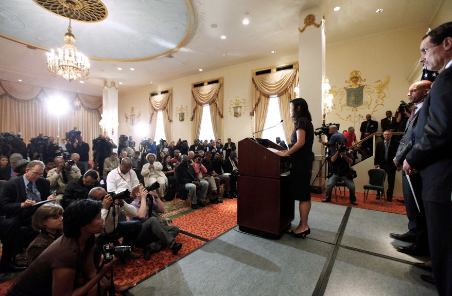 Michelle Rhee, the head of the D.C. public school system (center), announces her resignation on Wednesday. D.C. City Council Chairman Vincent C. Gray (far right) and Mayor Adrian M. Fenty look on. (Associated Press)