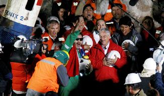 FREE AT LAST! Luis Urzua, the last of the 33 miners to be rescued from a collapsed mine near Copapio, Chile, celebrates next to Chilean President Sebastian Pinera Wednesday. The miners were trapped underground for 69 days. (Associated Press)