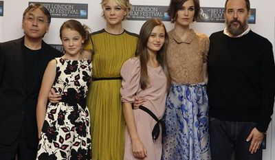 Japanese novelist Kazuo Ishiguro poses with British actresses Isobel Meikle-Small, Carey Mulligan, Ella Purnell, and Keira Knightley, alongside Director Mark Romanek, from left, during a photocall for the film &#39;Never Let Me Go&#39;, at a central London cinema, Wednesday, Oct. 13, 2010, ahead of the London Film Festival. (AP Photo/Joel Ryan)