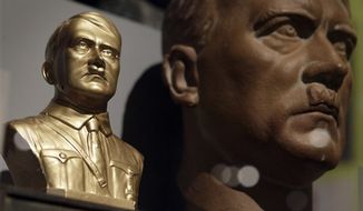 A bust of Adolf Hitler is pictured in front of a portrait of Hitler during a preview for the exhebition &#x27;Hitler and the Germans - nation and crime&#x27; in Berlin, Germany, Wednesday, Oct. 13, 2010. The exhibition runs from Oct. 15, 2010 until Feb. 6, 2011. (AP Photo/Michael Sohn)