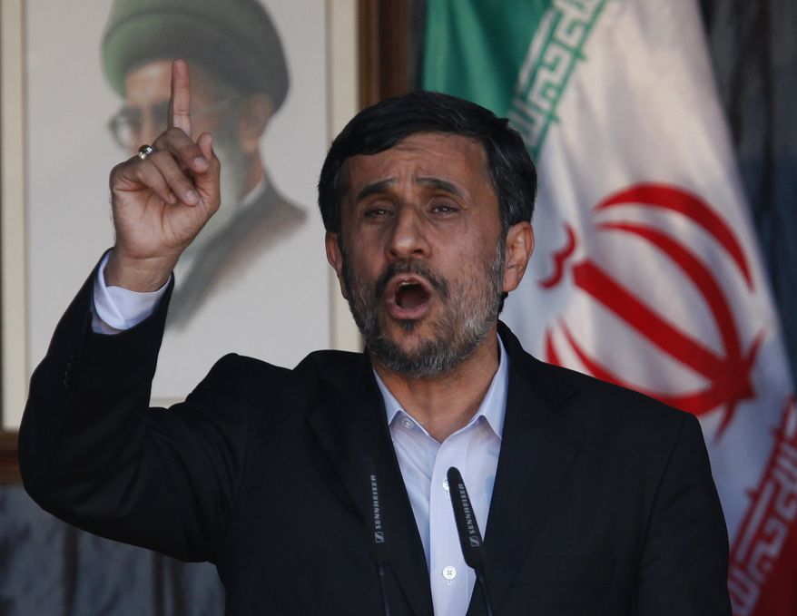 Iranian President Mahmoud Ahmadinejad gestures to his supporters during a rally organized by Hezbollah in the southern border town of Bint Jbeil, Lebanon, on Thursday Oct. 14, 2010. (AP Photo / Hussein Malla)