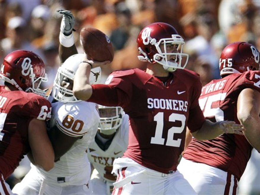 FILE - In this Oct. 2, 2010, file photo, Oklahoma quarterback Landry Jones (12) throws from the pocket during the first half of an NCAA football game against Texas at the Cotton Bowl in Dallas. The Sooners are getting back to gashing defenses with their hurry-up offense again, just as they did while setting scoring records during Sam Bradford's Heisman Trophy season two years ago. (AP Photo/LM Otero, File)