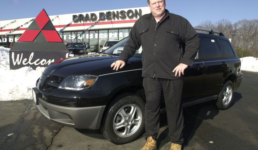 In this Feb. 20, 2003, file photo, car dealer Brad Benson, a former New York Giants center, stands in front of his car dealership in South Brunswick, N.J. The New Jersey car dealer who offered Florida pastor Terry Jones a new car if he promised to not burn a Koran plans to keep his word. (AP Photo, File)