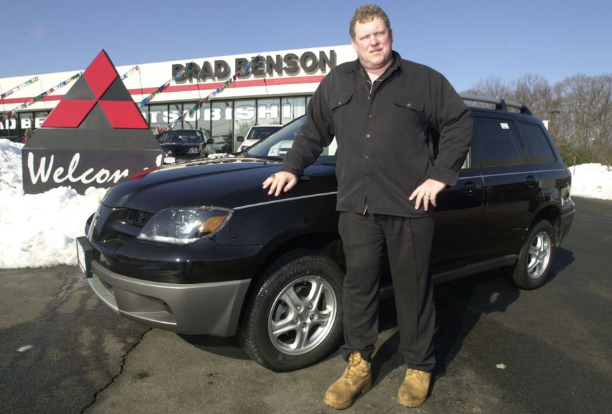 In this Feb. 20, 2003, file photo, car dealer Brad Benson, a former New York Giants center, stands in front of his car dealership in South Brunswick, N.J. The New Jersey car dealer who offered Florida pastor Terry Jones a new car if he promised to not burn a Koran plans to keep his word. (AP Photo, File)