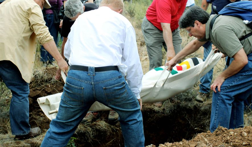 Friends and relatives carry Steve Sall&#39;s body to a grave at the White Eagle Memorial Preserve, a natural burial ground outside Goldendale, Wash. Sall, who died from complications from Lou Gehrig&#39;s disease, chose to be buried in this private forest. (Associated Press)