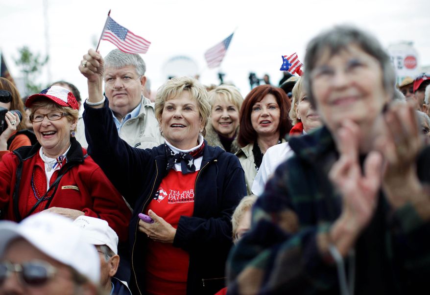 ASSOCIATED PRESS PHOTOGRAPHS
Attendees show their support during a rally launching a Tea Party Express bus tour Monday in Reno, Nev. The tour will make stops in at least 15 states before reaching Concord, N.H., the day before the midterm elections.