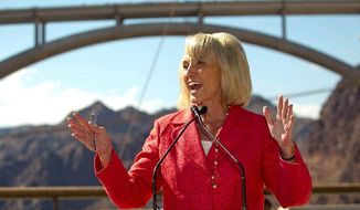 Arizona Gov. Jan Brewer improved her chances of keeping her seat when she signed into law a tough enforcement measure against illegal immigration. Polls show the Republican incumbent leading the race. (Arizona Republic via Associated Press)