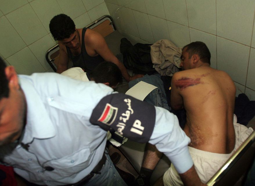 ** FILE ** In this Nov. 14, 2005, photo, Iraqi policemen show their bruises, allegedly caused by torture, as they are treated at Yarmouk hospital in Baghdad. The WikiLeaks website released nearly 400,000 documents on Friday, Oct. 22, 2010, that claim Iraqi forces mistreated, tortured and killed their captives as they battled a ruthless insurgency. (AP Photo/Khalid Mohammed)
