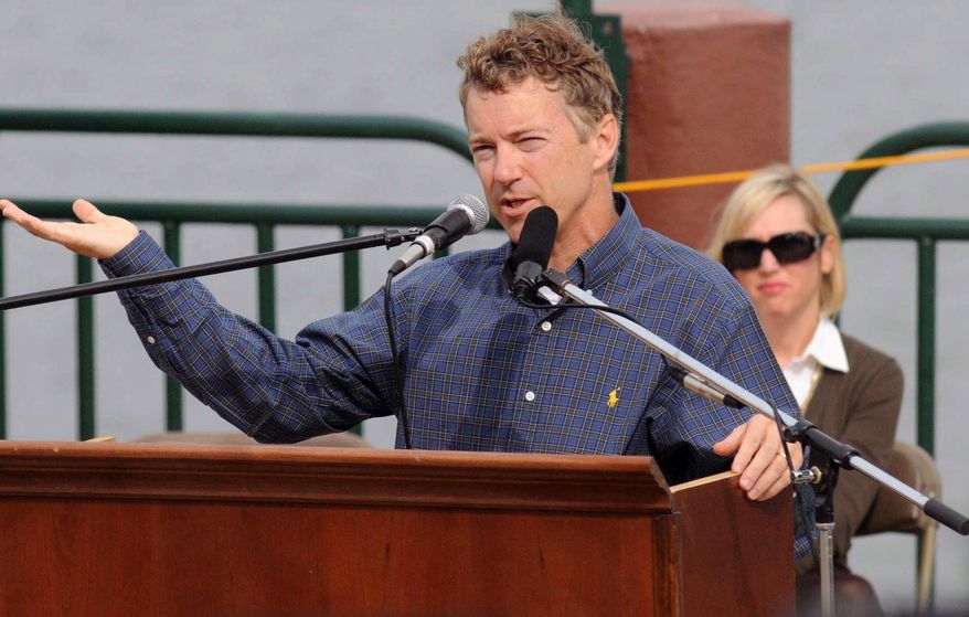 ASSOCIATED PRESS Republican U.S. Senate candidate Rand Paul addresses a large crowd at a Tea Party rally, Saturday, Oct. 23, 2010 on the riverfront in Paducah, Ky. Saturday, Oct. 23, 2010, as his wife Kelley looks on.