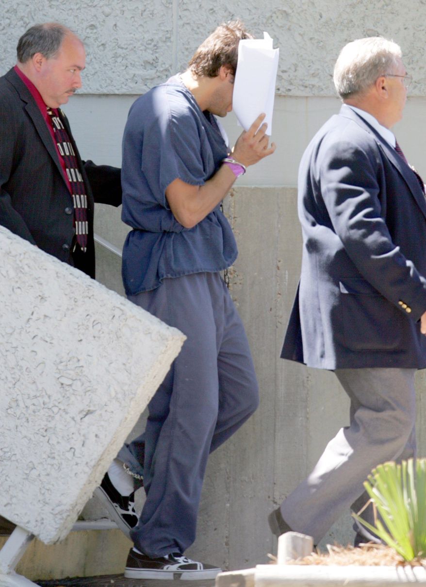 Seen here in April 2007, "Girls Gone Wild" creator Joe Francis uses papers to hide his face as he leaves the U.S. District Courthouse in Panama City, Fla. Francis is facing new legal jeopardy. (Associated Press)