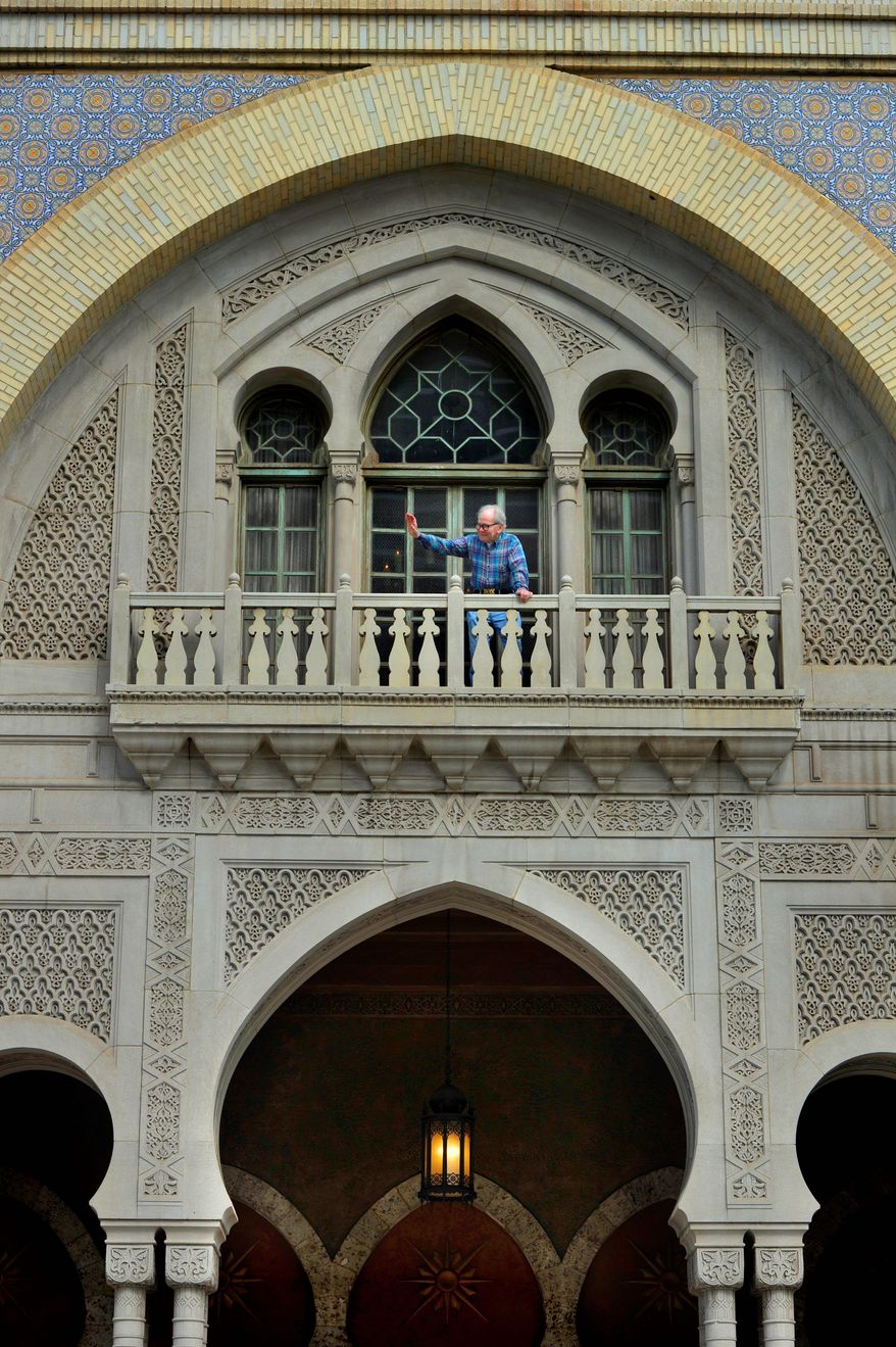 Joe Patten, 83, who has lived above the historic Fox Theatre in Atlanta for the past 31 years, waves to people on the street. Mr. Patten recently sued the Fox board in an attempt to remain living at the landmark. (Associated Press)