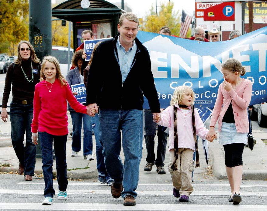 Sen. Michael Bennet, Colorado Democrat, walks with his three daughters to his polling place for early voting on Friday. From left are Caroline, 10; Anne, 5; and Halina, 9. (Associated Press)