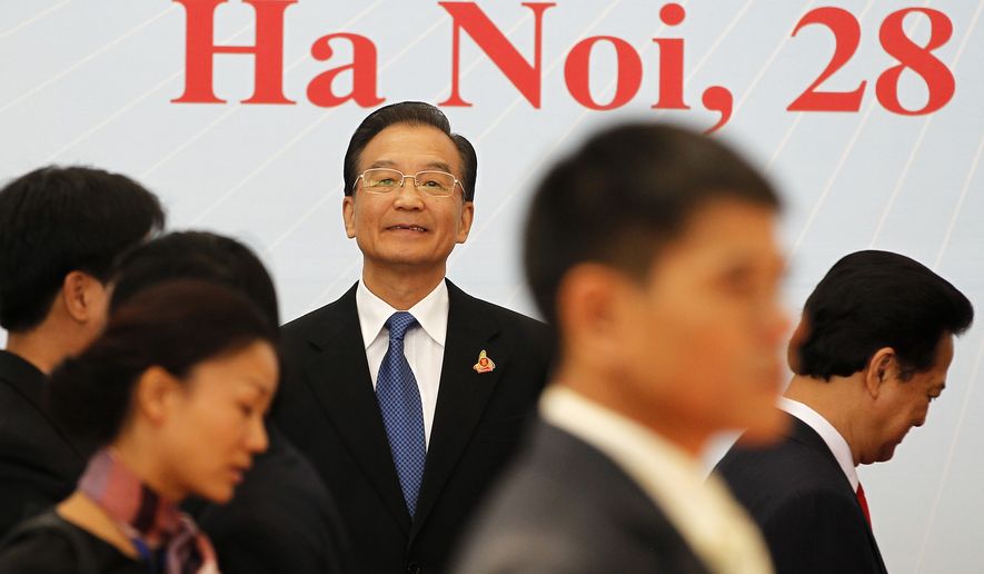 China's Premier Wen Jiabao waits for other leaders to arrive for a family photo during the 17th ASEAN Summit in Hanoi on Saturday, Oct. 30, 2010. (AP Photo/Damir Sagolj, Pool)