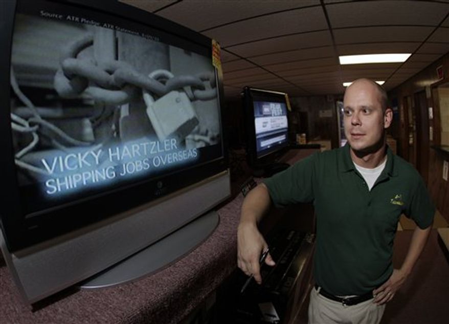 In this Oct. 27, 2010 photo, television repairman Josh Vannoy, who frequently hears complaints from customers about this year's political advertisements, stands next to a television showing a political ad at his store in Sedalia, Mo. Ads in U.S. House and Senate races have risen 50 percent; in gubernatorial races, they've more than doubled, according to figures from the Wesleyan Media Project, which analyzes ads. The political ad blitz has been an economic stimulus for broadcasters. For television viewers, however, the barrage of ads accusing politicians of being out-of-touch, corrupt liars can get overwhelmingly. (AP Photo/Charlie Riedel)