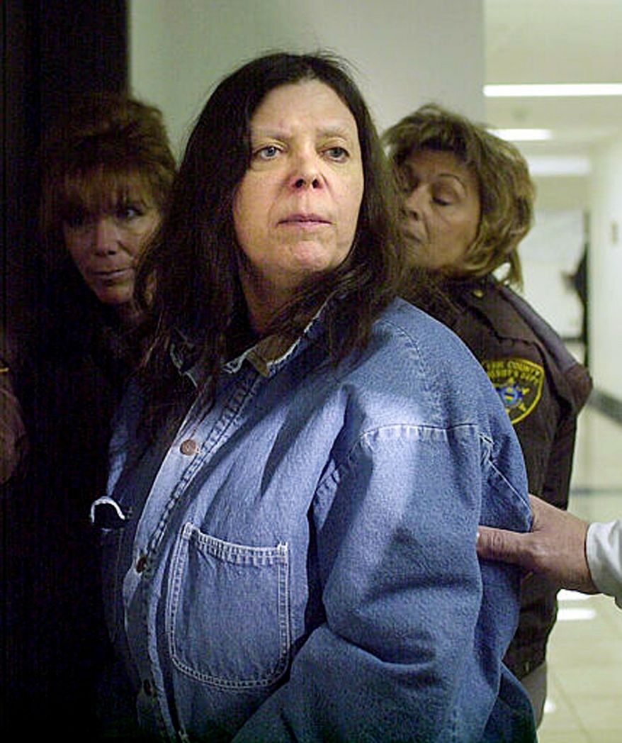 Marjorie Diehl-Armstrong, seen here in January 2004 being escorted to court in Erie, Pa., was convicted Monday of participating in a bizarre bank-robbery plot that ended in the death of a pizza-delivery driver in August 2003. Diehl-Armstrong, 61, vowed to appeal the conviction. (Associated Press)