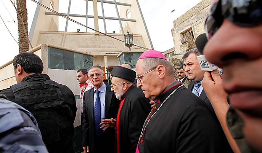 Iraqi Christian lawmaker, Younadem Kana, center left, Iraq&#39;s top Catholic prelate, Chaldean Cardinal Emmanuel III Delly, center, and Bishop Shlimone Wardoni, center right, are seen outside Our Lady of Deliverance church the morning after its congregation was taken hostage in Baghdad, Iraq, Monday Nov. 1, 2010. Iraqi security forces stormed a Baghdad church where militants had taken an entire congregation hostage for four hours, leaving dozens of people dead, including a priest, Iraqi officials said Monday.(AP Photo/Hadi Mizban)