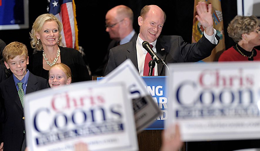 Sen.-elect Chris Coon, Delaware Democrat, celebrates his win Tuesday against Christine O'Donnell during an election night rally in Wilmington, Del. Coons is joined on stage by his wife, Annie, and two of his children. (Associated Press)