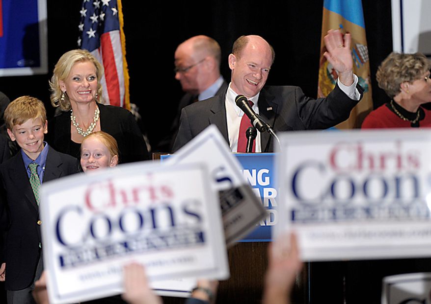 Sen.-elect Chris Coon, Delaware Democrat, celebrates his win Tuesday against Christine O'Donnell during an election night rally in Wilmington, Del. Coons is joined on stage by his wife, Annie, and two of his children. (Associated Press)