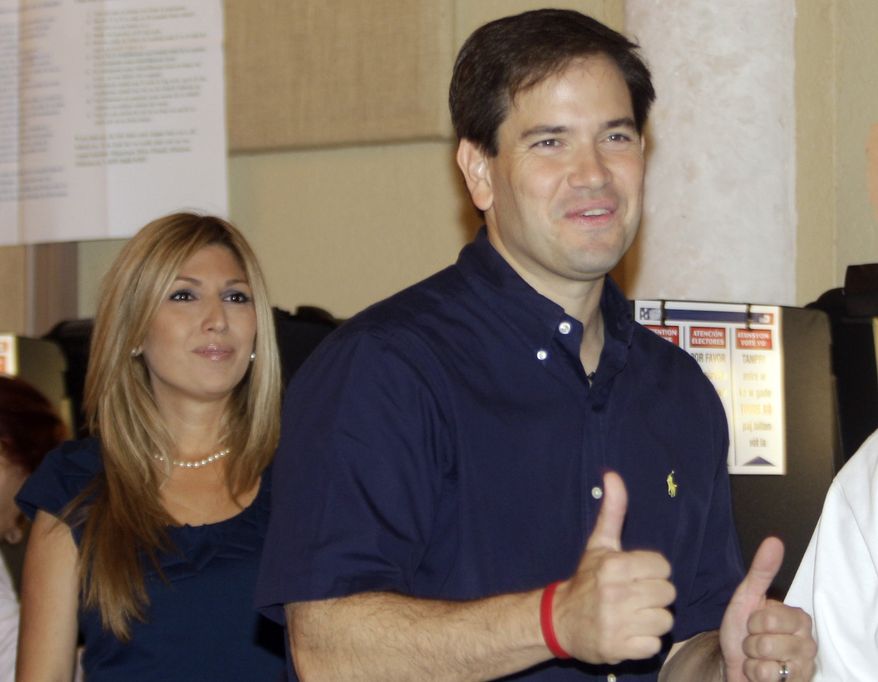 Florida Republican U.S. Senate candidate Marco Rubio gives two thumbs up after casting his vote as his wife Janette (left) looks on Tuesday in West Miami. (Associated Press)