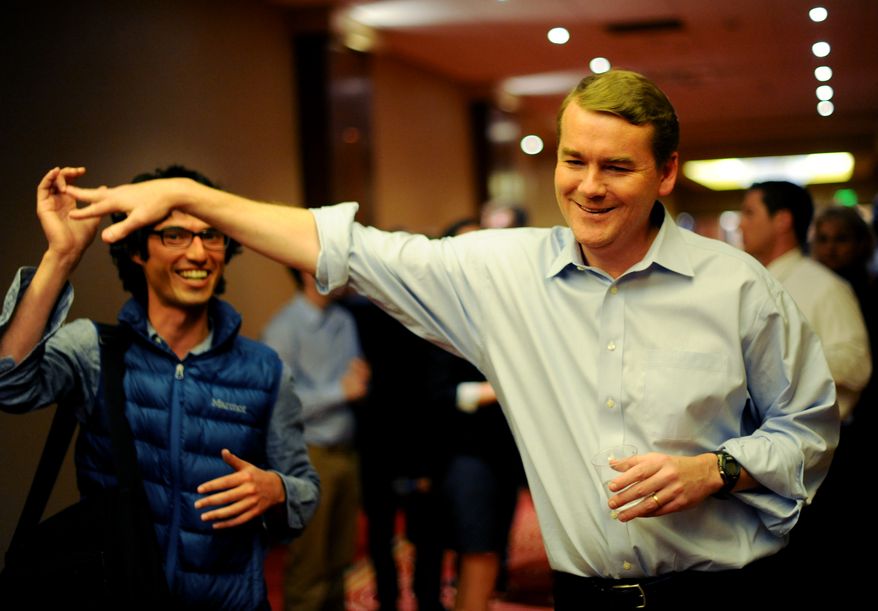 Senate candidate Michael Bennet, right, greets a supporter during an election night watch party in Denver, Tuesday, Nov. 2, 2010. (AP Photo/The Denver Post, Hyoung Chang)