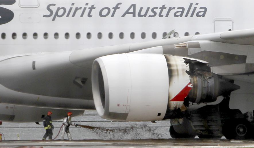 ** FILE ** Firefighters surround a Qantas Airbus A380 superjumbo jet after it made an emergency landing with 459 people aboard at Singapore&#39;s Changi International Airport after having engine problems on Thursday, Nov. 4, 2010. (AP Photo/Wong Maye-E, File)