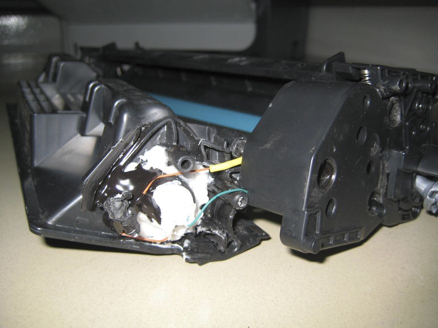 ** FILE ** This undated file photo released by the Dubai Police via the state Emirates News Agency (WAM) on Saturday, Oct. 30, 2010, claims to show parts of a computer printer with explosives loaded into its toner cartridge found in a package onboard a cargo plane coming from Yemen, in Dubai, United Arab Emirates. (AP Photo/Dubai Police via Emirates News Agency, File)