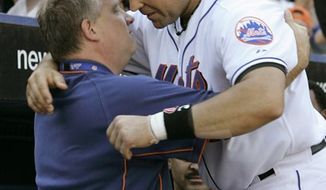 FILE - In this Oct. 2, 2005, file photo, then-New York Mets catcher Mike Piazza embraces Mets clubhouse manager Charlie Samuels after a tribute to Piazza&#39;s seven-year career with the Mets, during a baseball game against the Colorado Rockies in New York. A person familiar with the investigation says the Mets suspended Samuels because he&#39;s involved in an investigation into illegal gambling being conducted by the Queens District Attorney and the New York Police Department. The team announced the suspension Thursday, Nov. 4, 2010, but did not explain it. (AP Photo/Kathy Willens, File)