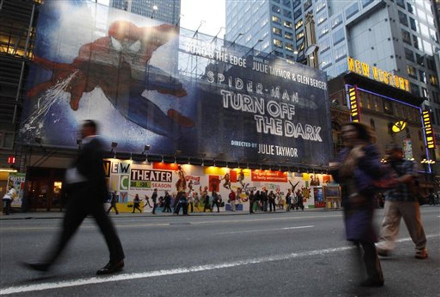 FILE - In this Oct. 5, 2010 file photo, a building-sized banner covers the front of the Foxwoods Theater on 42nd street in New York, where preparations are underway for the opening of Spider-Man, the most expensive show in Broadway history. Producers of "Spider-Man Turn Off the Dark" are delaying by three weeks the opening of the costly and complicated show, meaning it will only be available for previews after the busy Thanksgiving holiday. Originally scheduled to begin previews on Nov. 14 with an opening four days before Christmas, the show will now begin previews on Nov. 28 and open Jan. 11. (AP Photo/Kathy Willens, File)