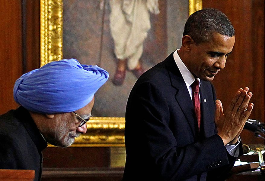 ** FILE ** President Obama (right) bows as he makes a greeting to the audience beside Indian Prime Minister Manmohan Singh after delivering a speech at Parliament House in New Delhi on Monday, Nov. 8, 2010. (AP Photo/Jim Young, Pool)