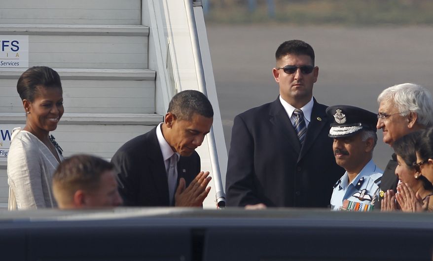 U.S. President Barack Obama, greets the Indian delegation present at the airport to see him off in the traditional Indian way of namaste as he leaves for Indonesia at the end of their tour of India, at the airport in New Delhi, India, on Tuesday, Nov. 9, 2010. (AP Photo/Saurabh Das)