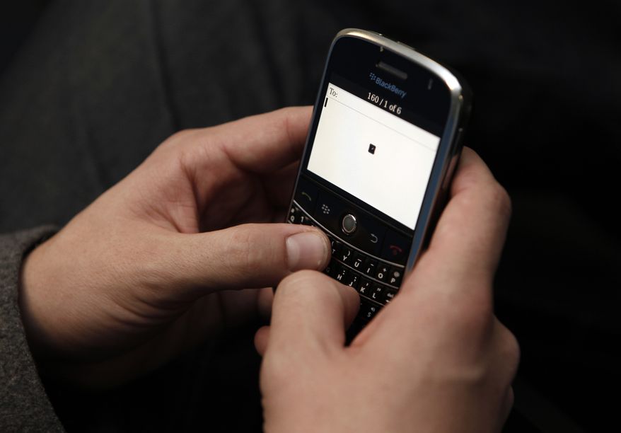 ** FILE ** This photo from Feb. 11, 2009, shows an owner beginning to write a text message on his cellphone in Los Angeles. (Associated Press)