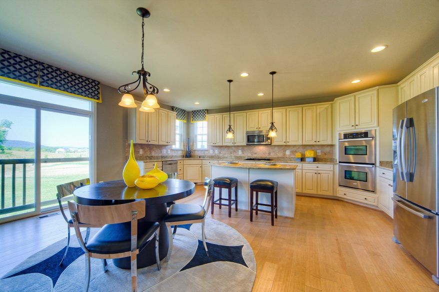 The Kingston II model at Village Green has a center-island kitchen with a breakfast area and pantry. The home, which has nearly 3,000 finished square feet, can be expanded with a morning room, a sunroom, a rear extension and a finished lower level.
