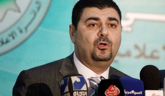 Government spokesman Haider al-Mullah speaks to the news media in Baghdad on Thursday. Parliament met later in the day to form a new government. (Associated Press)