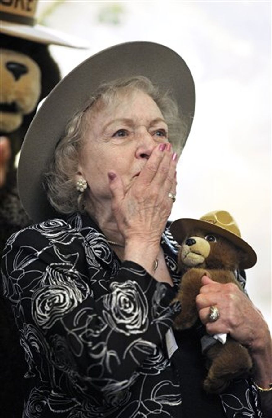 A wooden plague given to actress Betty White is seen during a ceremony where she was named an Honorary Forest Ranger by the US Forest Service, at the Kennedy Center in Washington Washington, Tuesday, Nov. 9, 2010. White has stated in numerous interviews that her first ambition as a young girl was "to become a forest ranger, but they didn't allow women to do that back then". (AP Photo/Cliff Owen)