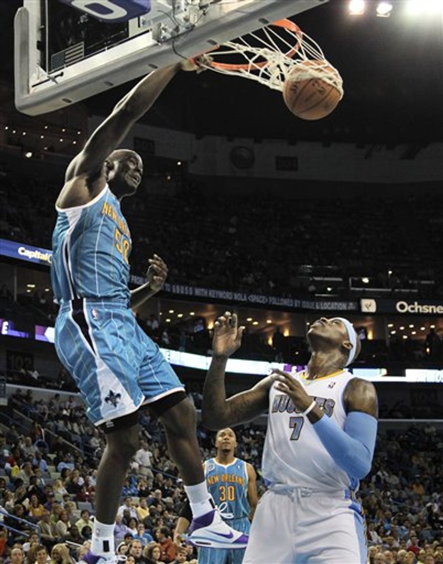FILE - This Oct. 29, 2010, file photo shows New Orleans Hornets center Emeka Okafor (50) dunking over Denver Nuggets power forward Al Harrington (7) in the second half of an NBA basketball game in New Orleans. Coming off perhaps his worst season, Emeka Okafor is now primed for one of his best with the resurgent Hornets. (AP Photo/Gerald Herbert, File)