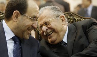 In this June 27, 2009, file photo, Iraq&#39;s Prime Minister Nouri al-Maliki, left, and President Jalal Talabani, right, react, at a ceremony marking the 2003 death of Mohammed Baqir al-Hakim in Baghdad. (AP Photo/Hadi Mizban, File)