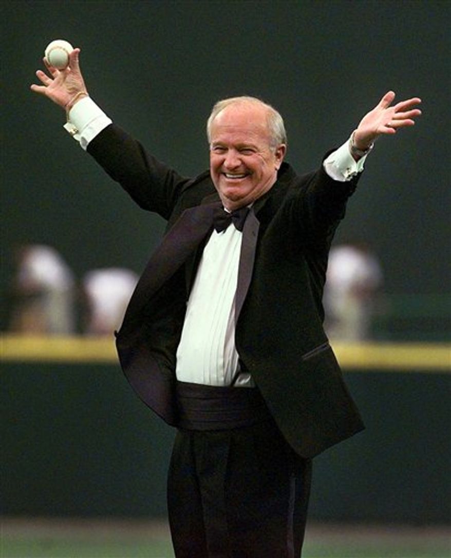 FILE - In this July 15, 1999, file photo, Dave Niehaus waves to the crowd after a surprise announcement that he would be tossing out the ceremonial first pitch at the inaugural game of the Seattle Mariners' new ballpark, Safeco Field, in Seattle. Niehaus, the legendary and beloved voice of the Mariners from their inception in 1977 through the final game of the 2010 season, has died, the ballclub confirmed Wednesday, Nov. 10, 2010. Niehaus, who received the Ford Frick Award at the Hall of Fame induction ceremony in 2008, was 75. (AP Photo/Elaine Thompson, File)
