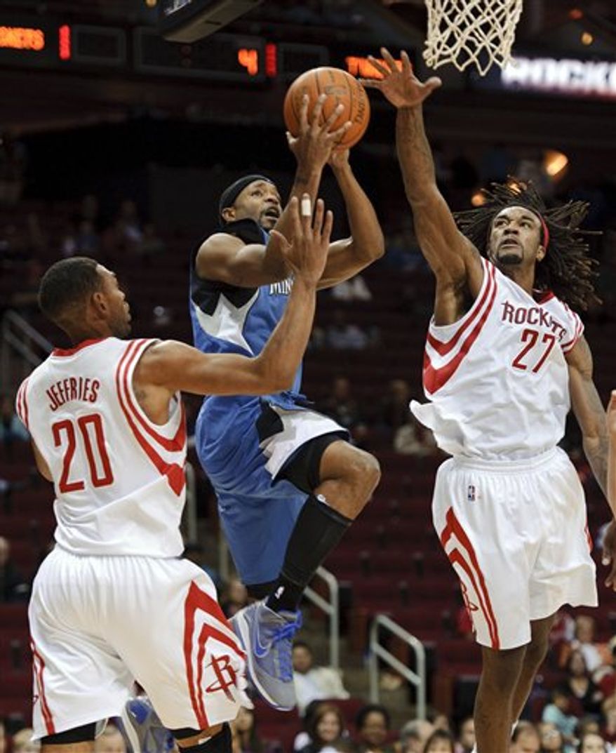 Houston Rockets center Yao Ming, of China, right, sits with his left foot wrapped on the bench during the second quarter of an NBA basketball game against the Minnesota Timberwolves Sunday, Nov. 7, 2010, in Houston. Shane Battier is at left. (AP Photo/Dave Einsel)