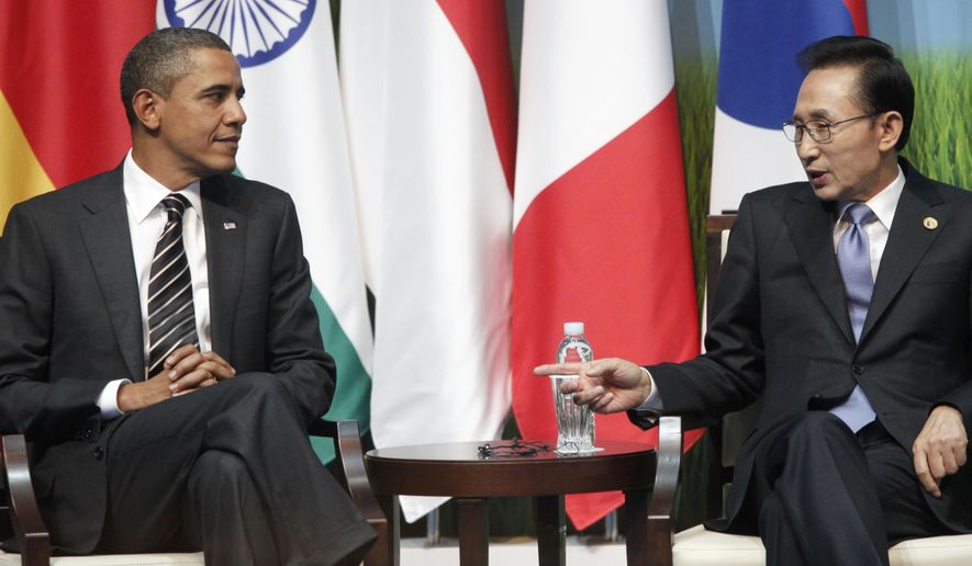 President Obama and South Korean President Lee Myung-bak and Canadian Prime Minister Stephen Harper, unseen, talk during the G-20 SME Finance Challenge Award winners ceremony at the G-20 summit in Seoul, South Korea, Friday, Nov. 12, 2010. (AP Photo/Pablo Martinez Monsivais)