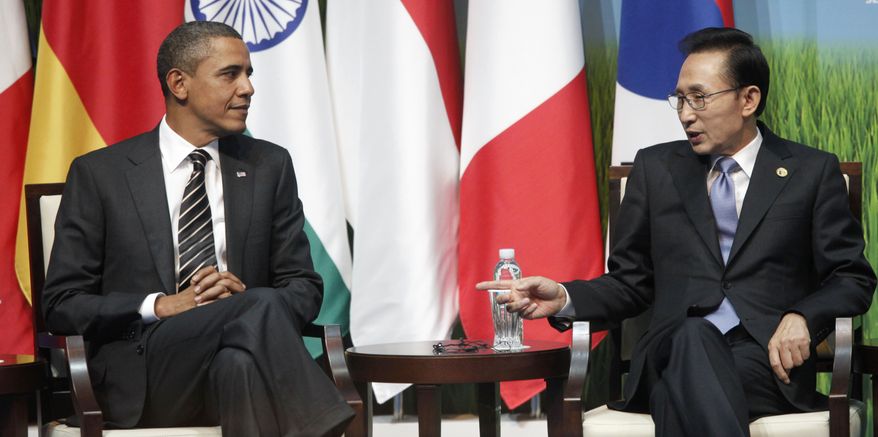 President Obama and South Korean President Lee Myung-bak and Canadian Prime Minister Stephen Harper, unseen, talk during the G-20 SME Finance Challenge Award winners ceremony at the G-20 summit in Seoul, South Korea, Friday, Nov. 12, 2010. (AP Photo/Pablo Martinez Monsivais)