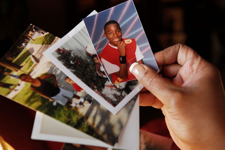 J.M. EDDINS JR./THE WASHINGTON TIMES
KEEPSAKES: LaVonne Abney's living room in Southwest Washington is a memorial to her son, Chicquelo, who was shot and killed a block from his mother's apartment.