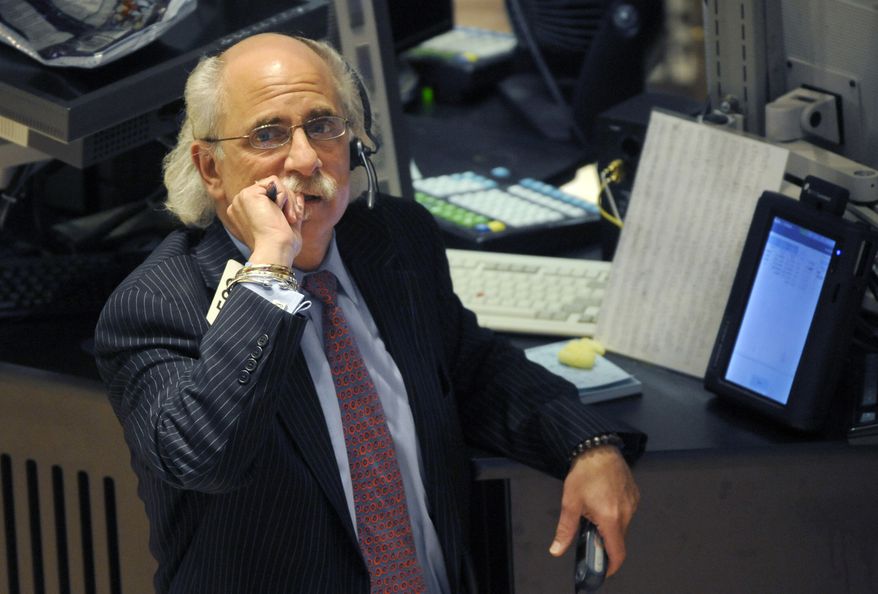 Peter Tuchman works on the floor of the New York Stock Exchange, Tuesday, Oct. 19, 2010, in New York. The Dow Jones industrial average fell below 11,000 for the first time in nearly a month Tuesday, Nov. 16, 2010, as worries mounted about inflation in Asia and as European leaders met to discuss a bailout of Ireland. (AP Photo/Henny Ray Abrams)